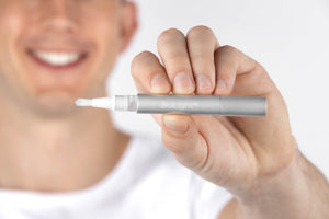 Guardian+ Oral Device from BioLight, depicted with charging components and instruction manual for at-home use.
